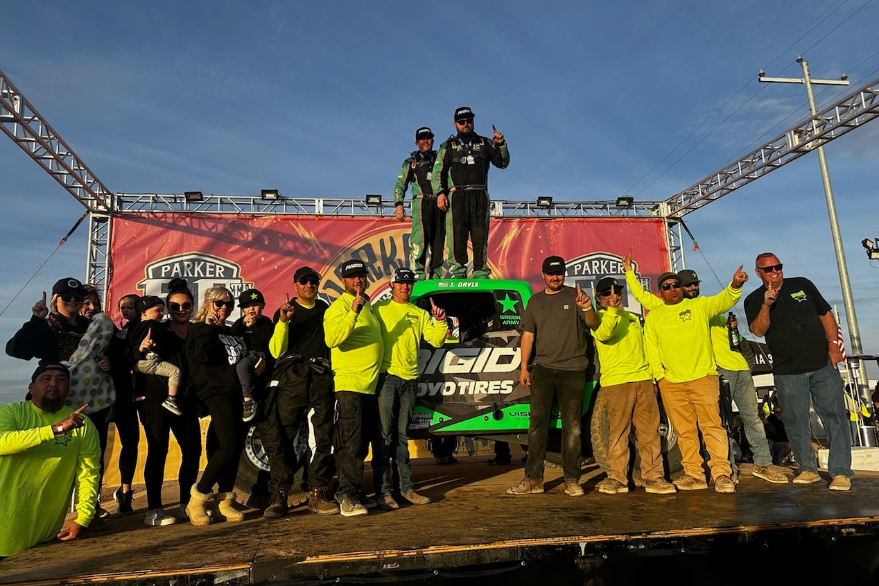 Off-Roading Team Standing Together in Front of Truck