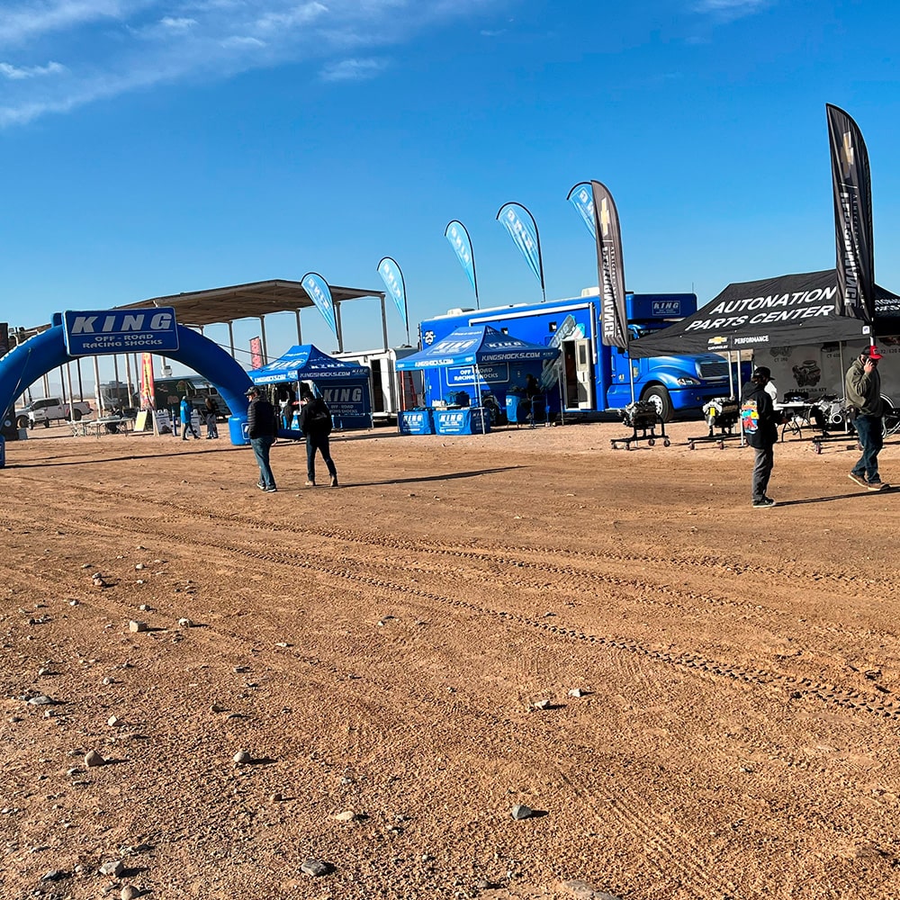 Members of Off-Roading Team Standing Around AutoNation Parts Center Tent and RV