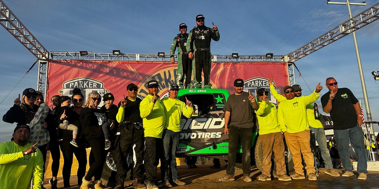 Off-Roading Team Standing Together in Front of Truck