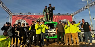 Off-Roading Team Standing Together in Front of Truck