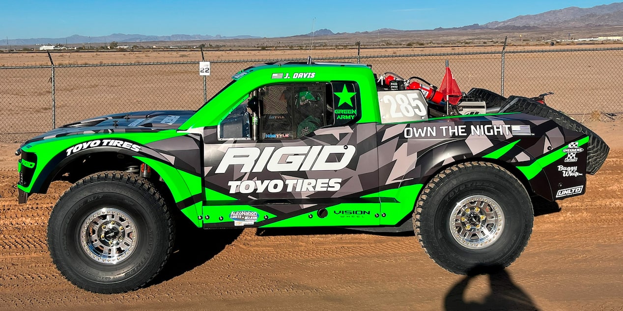 Left View of an Off-Roading Truck with Black, Green, and White Graphics