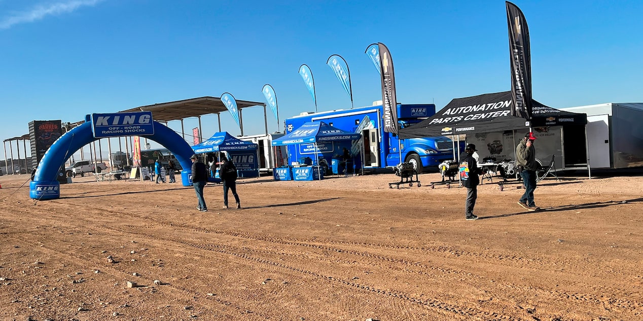 Members of Off-Roading Team Standing Around AutoNation Parts Center Tent and RV