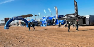 Members of Off-Roading Team Standing Around AutoNation Parts Center Tent and RV