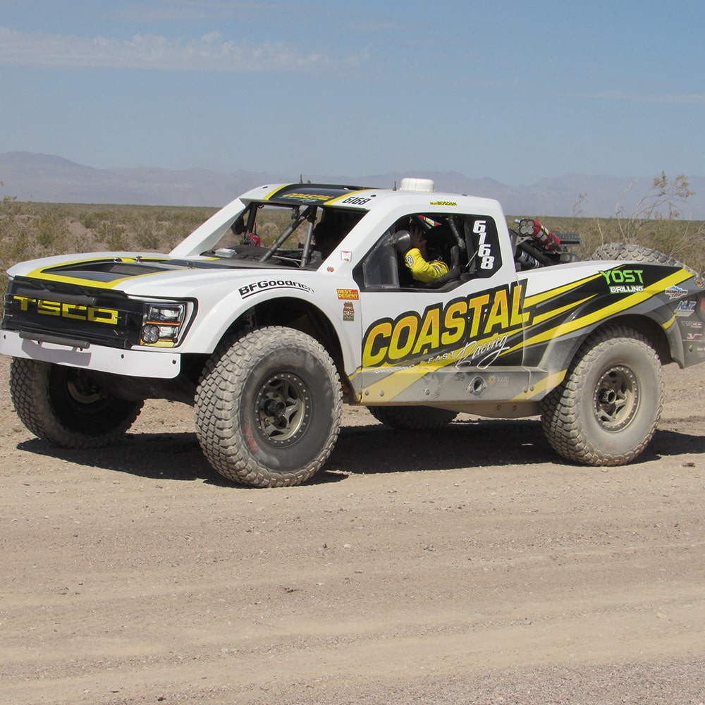 Left View of a White Truck Off-Roading