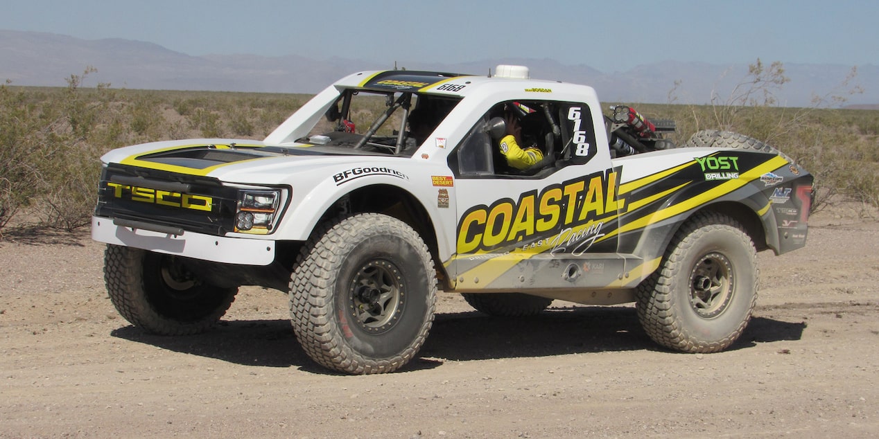 Left View of a White Truck Off-Roading