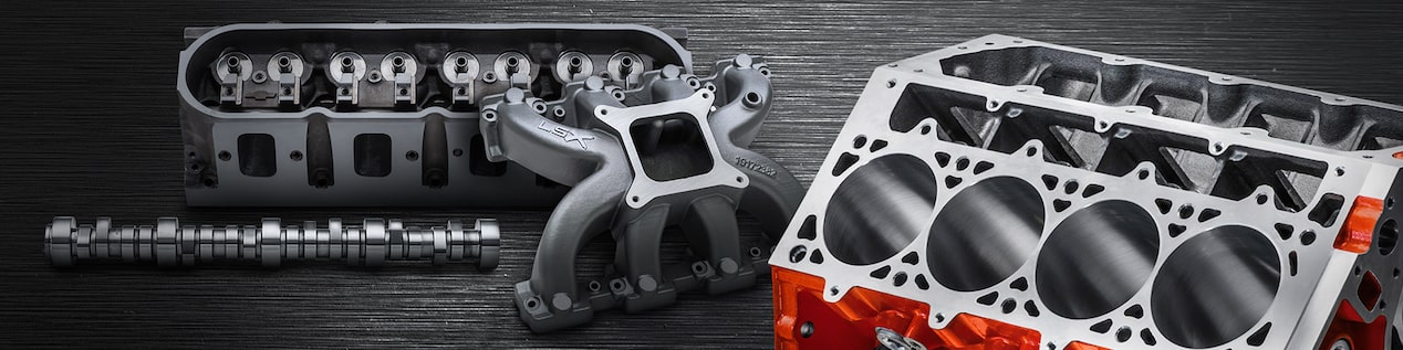 A Chevrolet Performance Parts Engine Block with Red Trim and Other Auto Components Against a Stylized Black Background