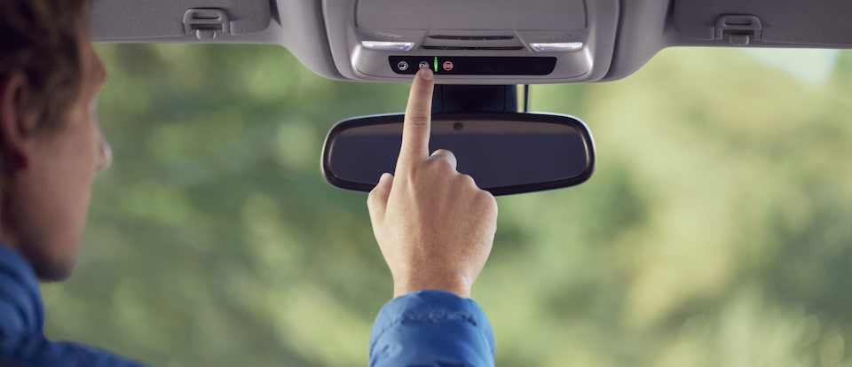 Miembro de My Chevrolet Rewards presionando el botón de servicios OnStar
