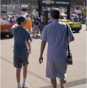 Father and son exploring vehicles at 2023 Daytona 500