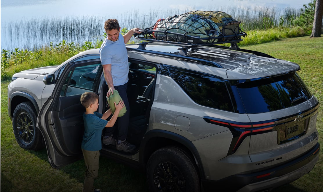 man and child loading camping gear