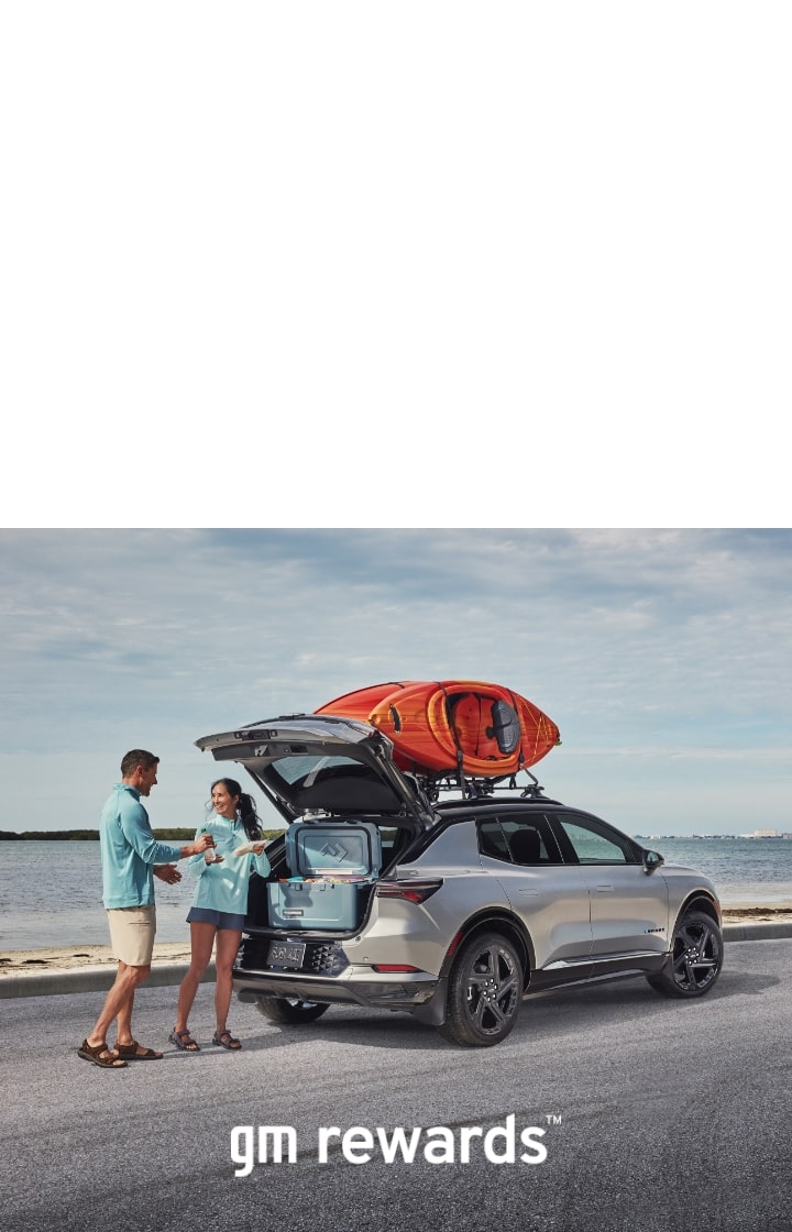 2 people with a kayak on a car