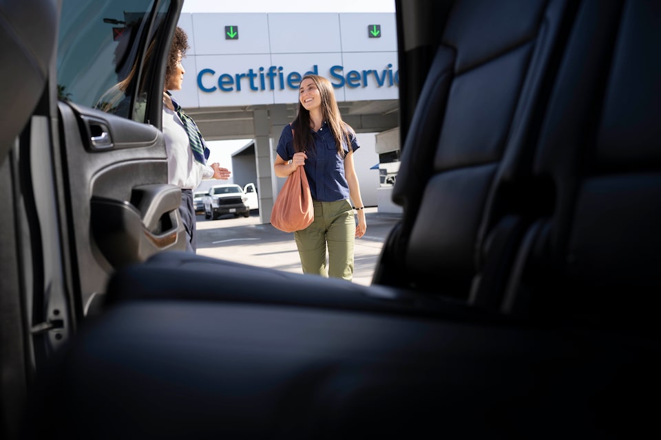 Car Sales Person Showing a Customer a Certified Used Vehicle