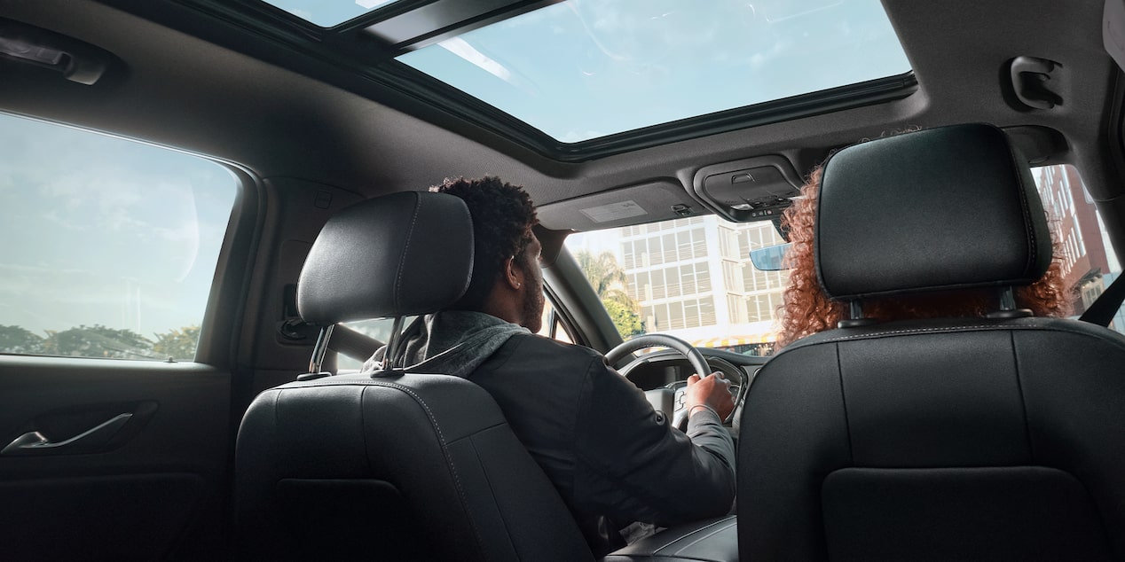 Rear View of a Man and Woman Sitting on the Front Seats of a Chevy Blazer