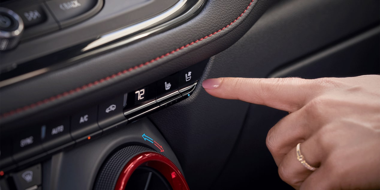 A Finger Going to Click on One of the Buttons in the Control System