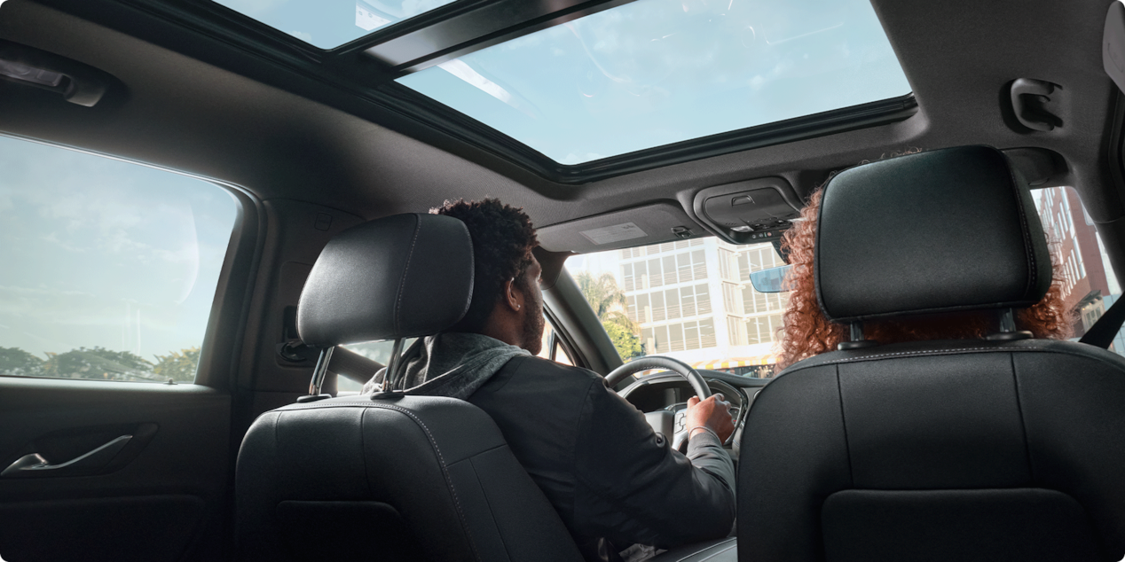 Rear View of a Man and Woman Sitting on the Front Seats of a Chevy Blazer