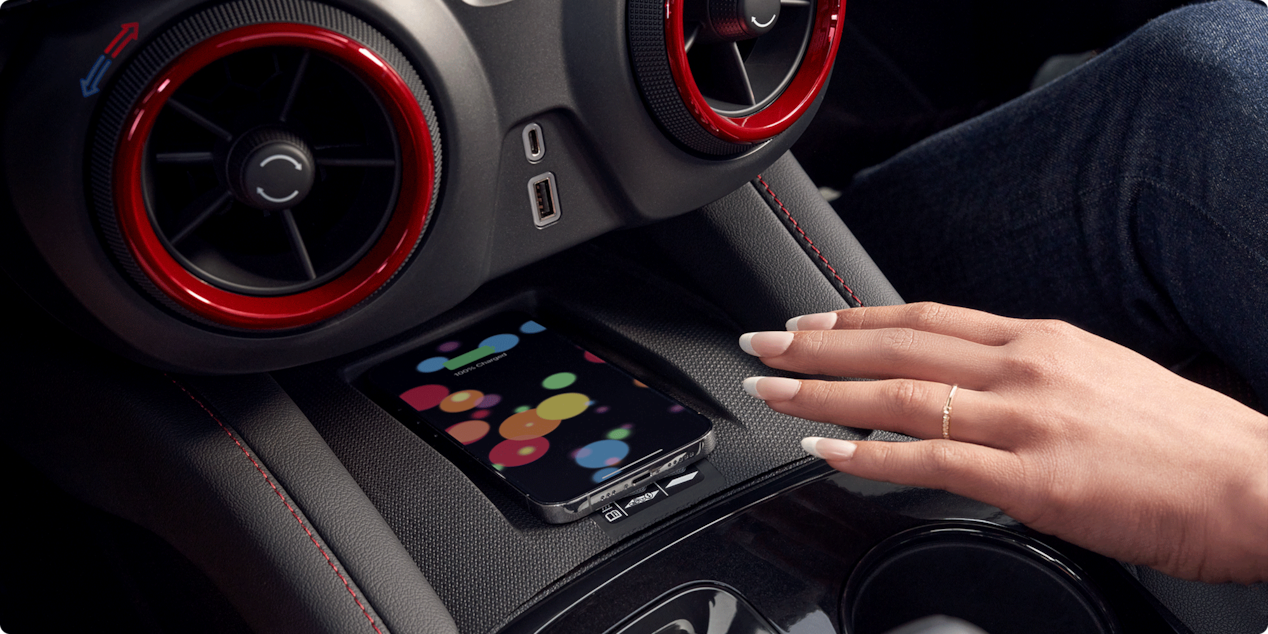 Woman Using Wireless Smart Phone Charging Inside the 2026 Chevy Blazer