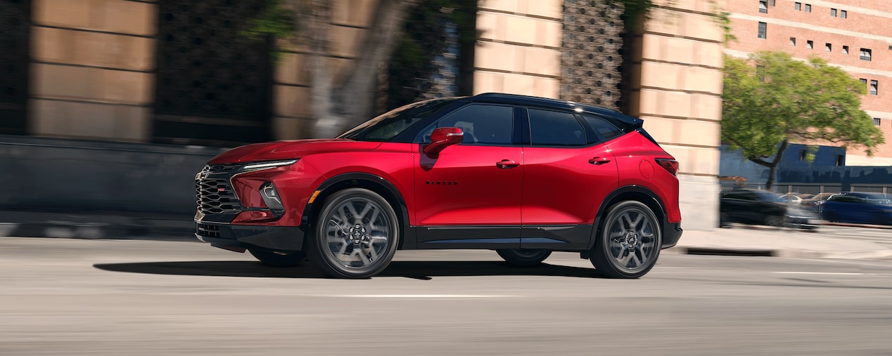 Red 2026 Chevy Blazer Driving Passed Store Fronts