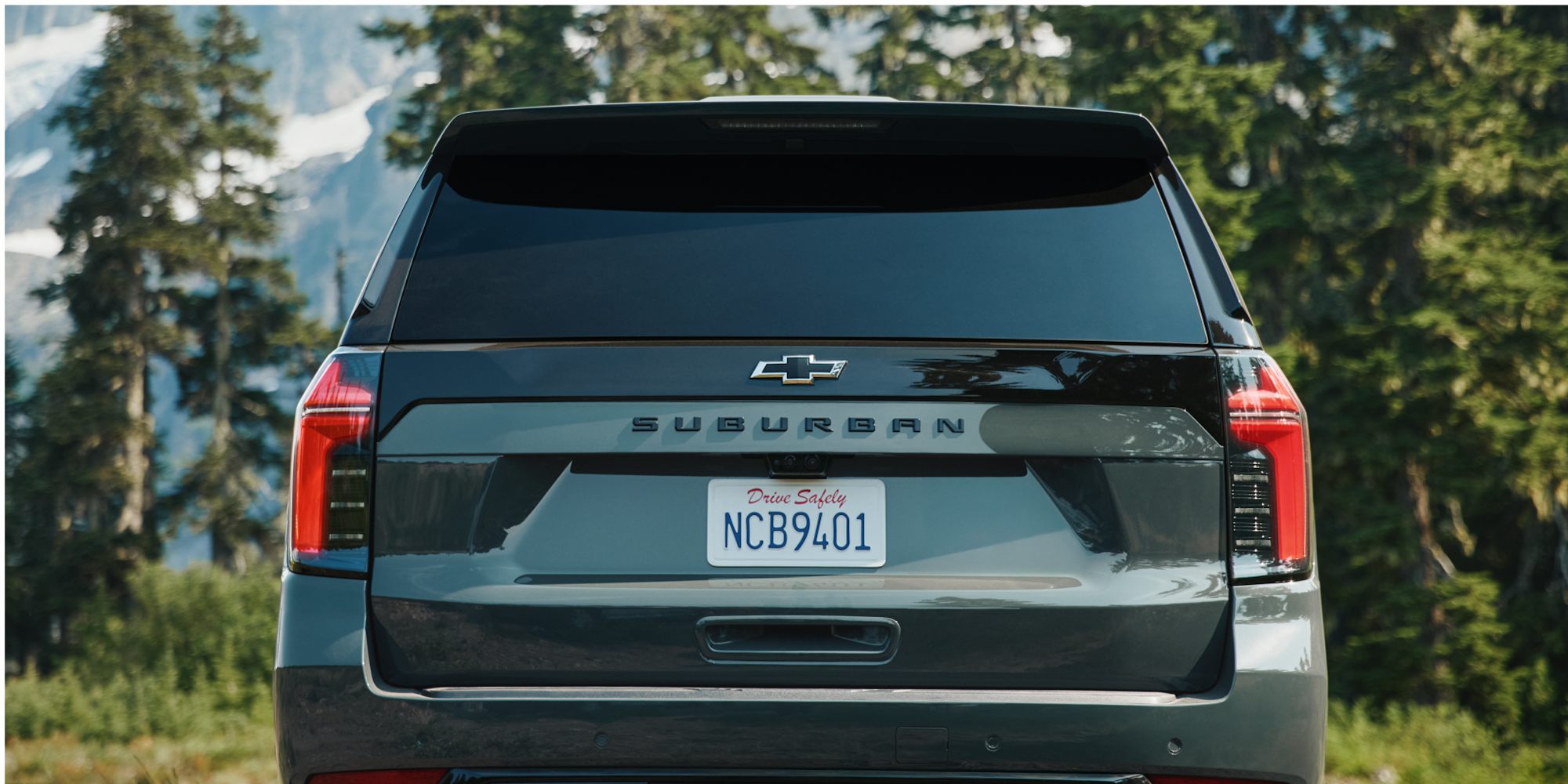 The Rear View of the 2026 Chevy Suburban Parked in a Wooded Area