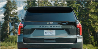 The Rear View of the 2026 Chevy Suburban Parked in a Wooded Area