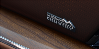 Close-up of the 2026 Chevy Suburban "High Country" Trim Nameplate in the Interior