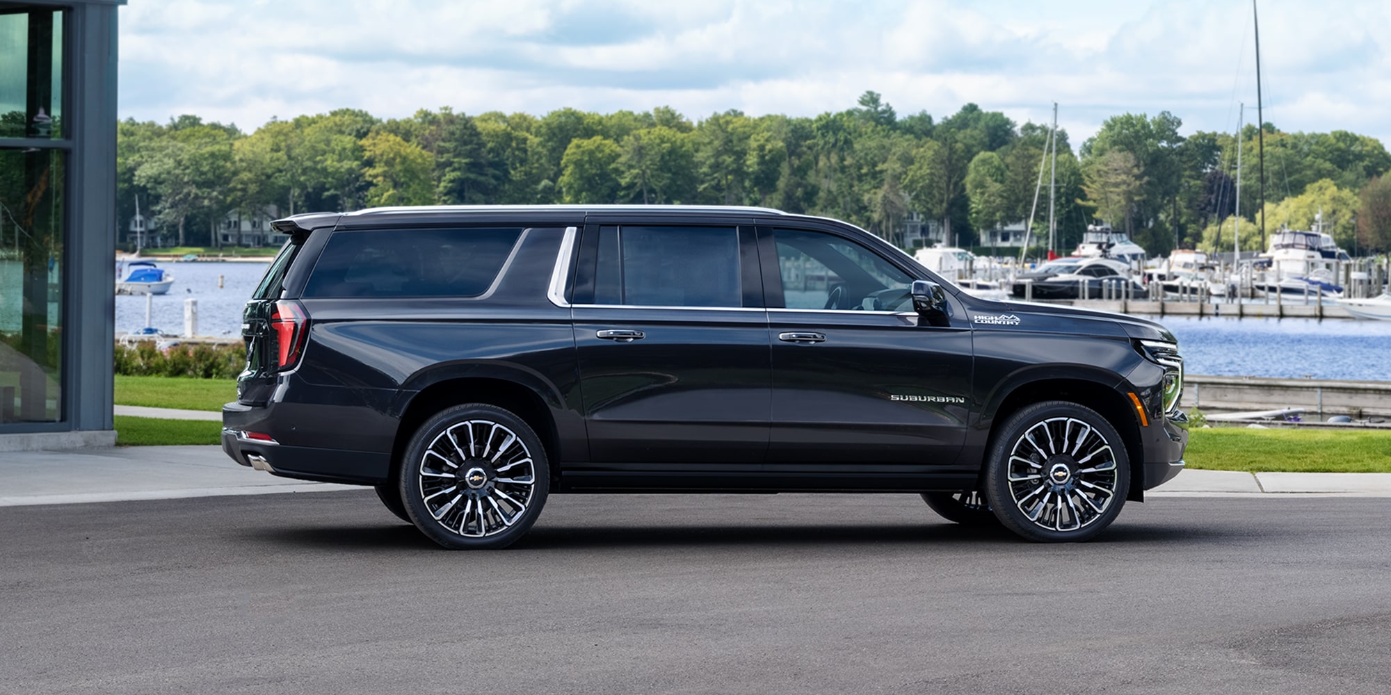 Profile View of the 2026 Chevrolet Suburban SUV Passenger Side Parked Near a Boating Dock