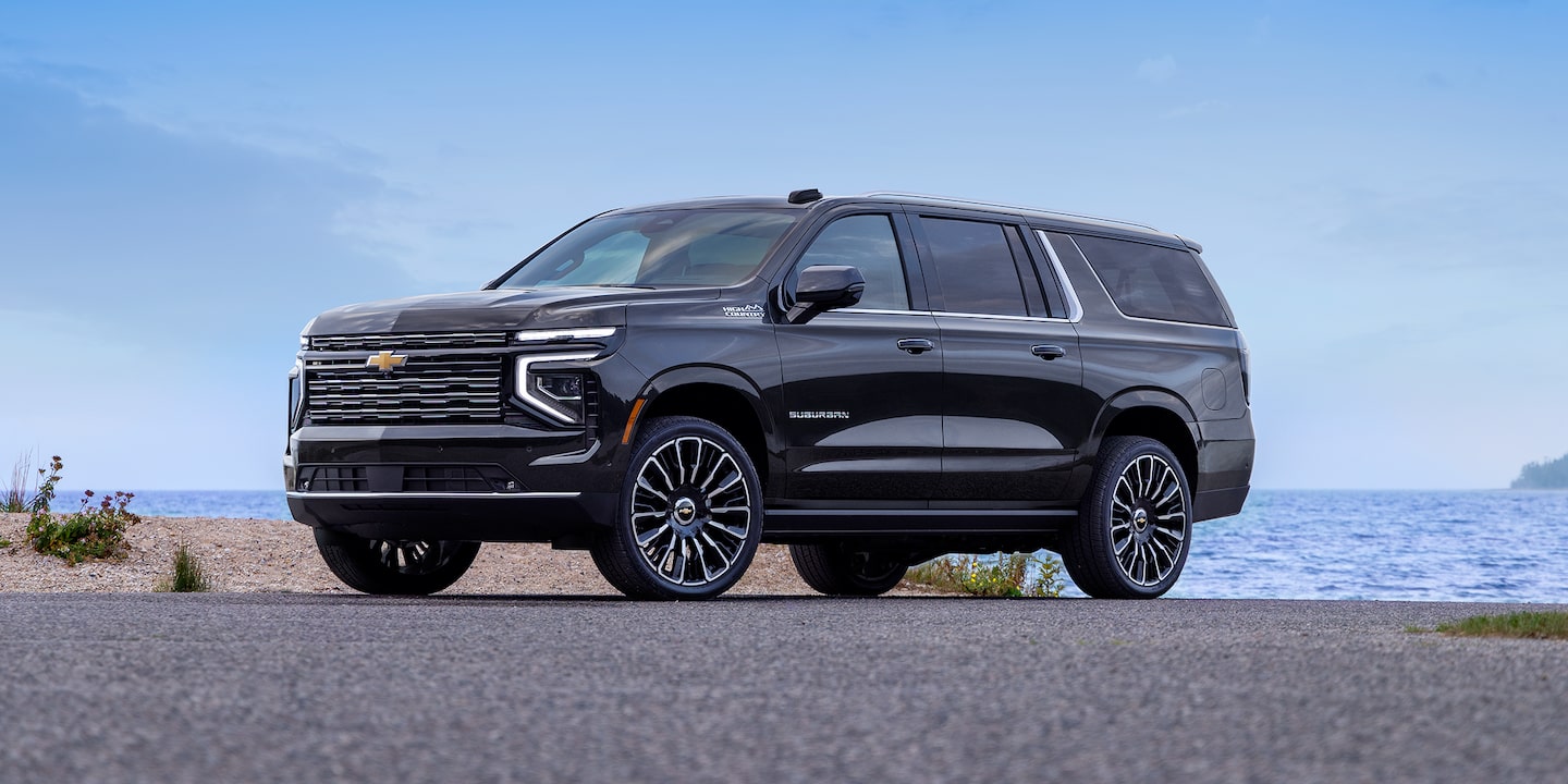 Front three-quarter view of the 2026 Chevrolet Suburban parked near the lake
