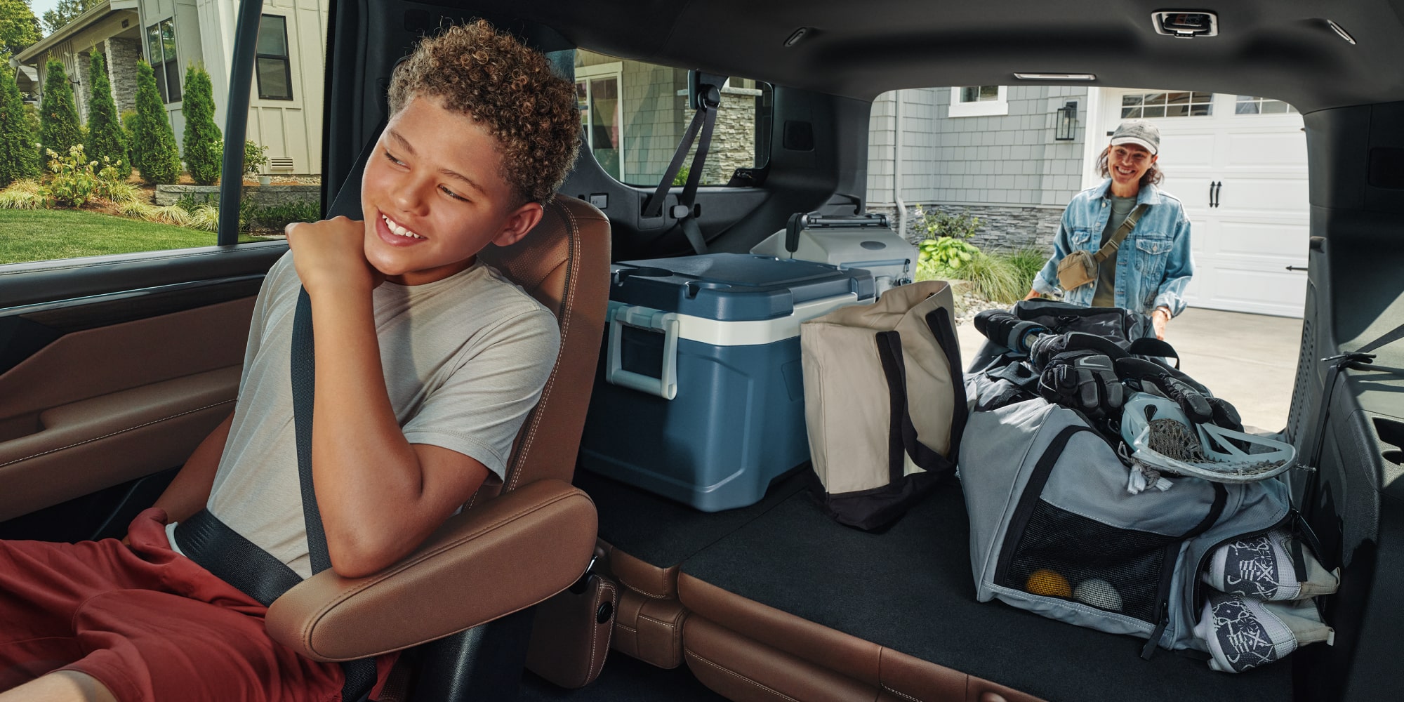 Third Row Folded Down While a Family Loads Up the Trunk of Their 2026 Chevy Suburban