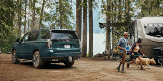 Camping with 2026 Tahoe in background
