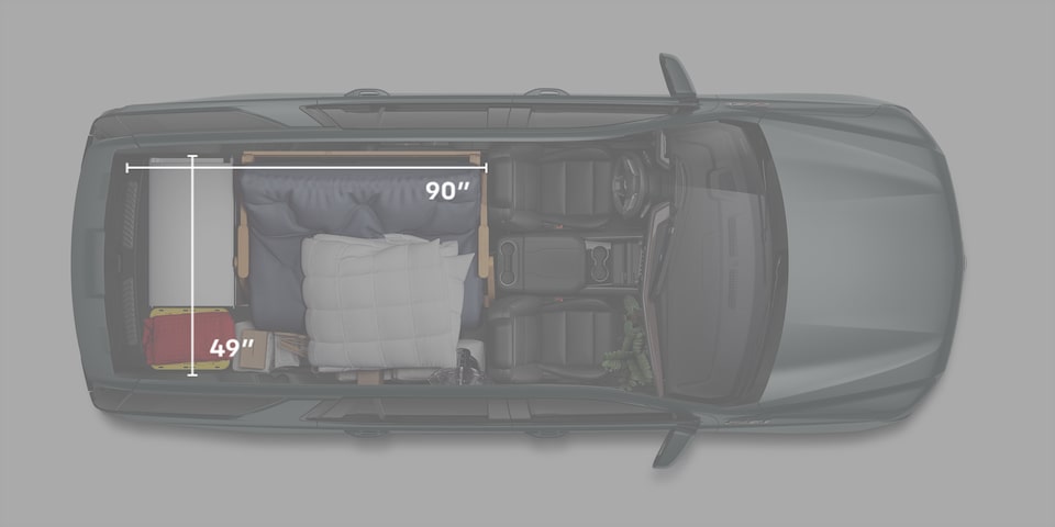 2026 Chevrolet full-size SUV cargo area with storage bins (both rows folded)