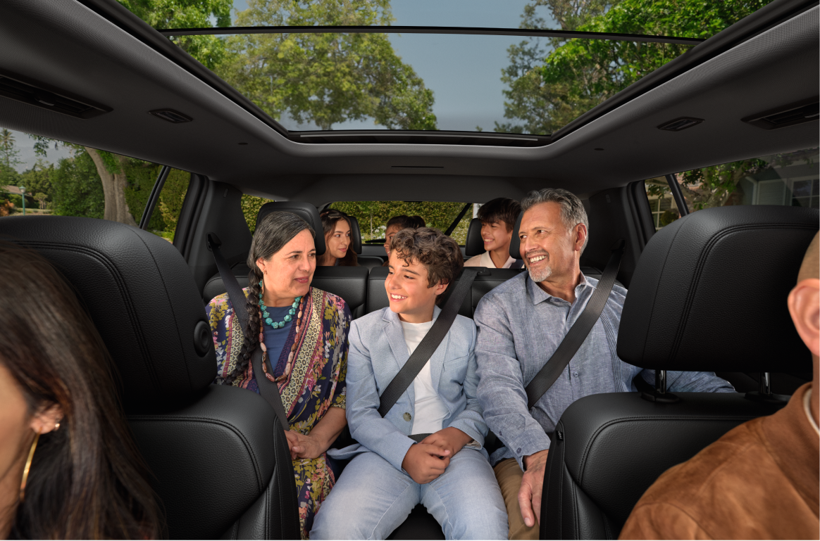 Passengers Riding in the Spacious Interior of a 2027 Chevy Traverse Featuring Three Rows of Seating and a Panoramic Sunroof.