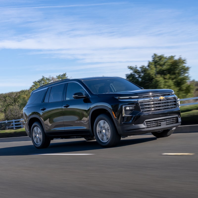 A 2027 Chevy Traverse Driving on a Highway Showcasing a Strong Side Profile and Modern Exterior Styling.