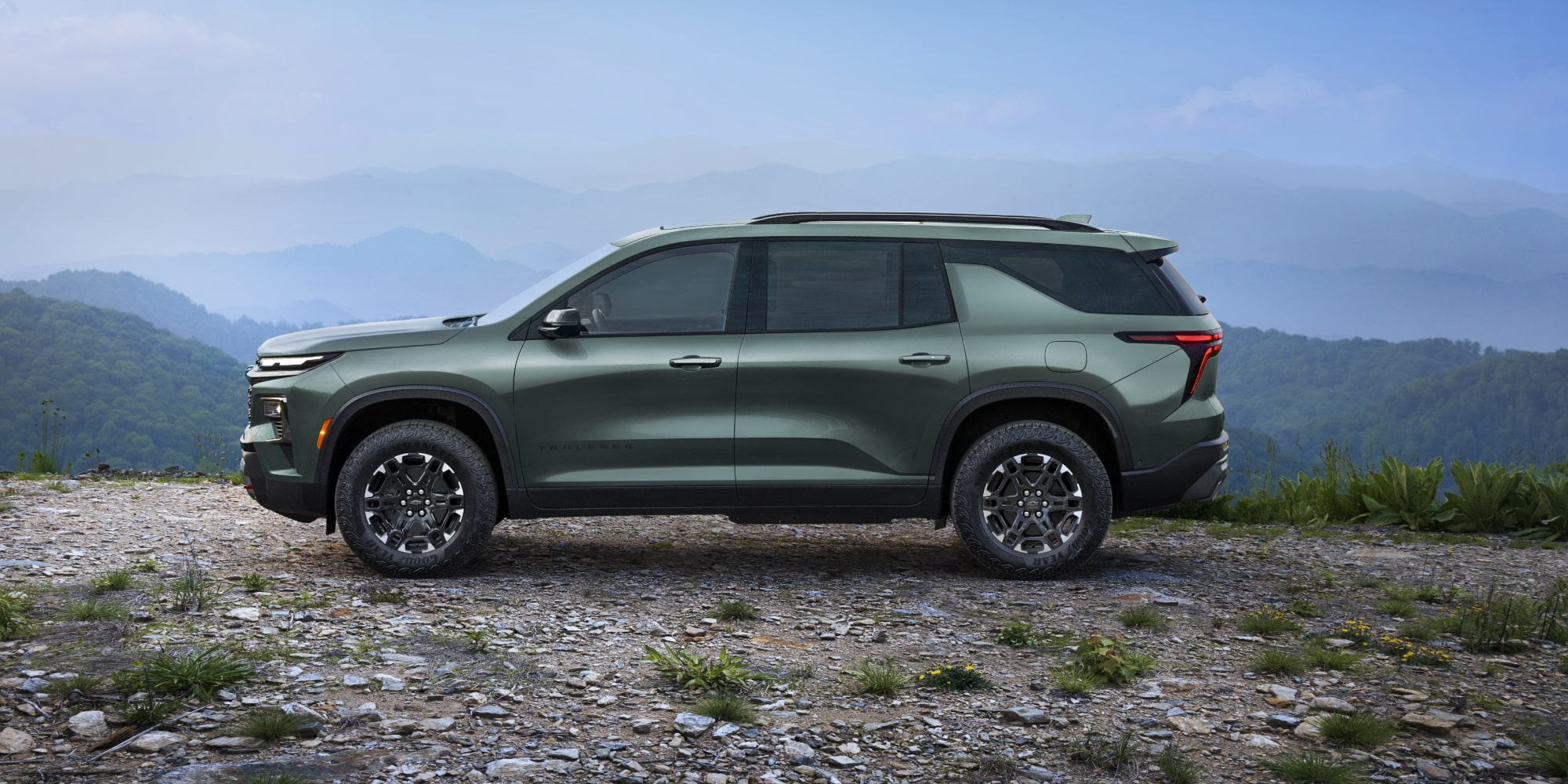 A 2027 Chevy Traverse Parked at a Scenic Overlook Showcasing a Strong Side Profile and Modern SUV Styling.
