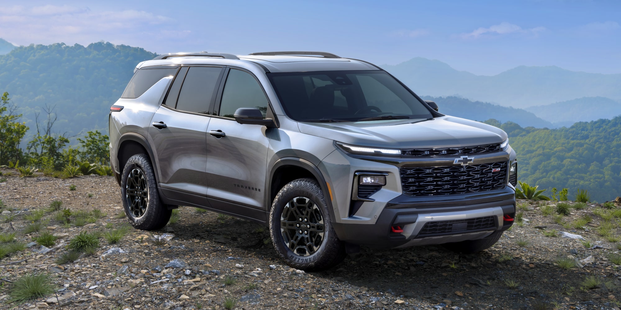 A 2027 Chevy Traverse Parked at a Scenic Overlook Showcasing a Bold Front Grille and Rugged SUV Styling.
