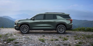 A 2027 Chevy Traverse Parked at a Scenic Overlook Showcasing a Strong Side Profile and Modern SUV Styling.