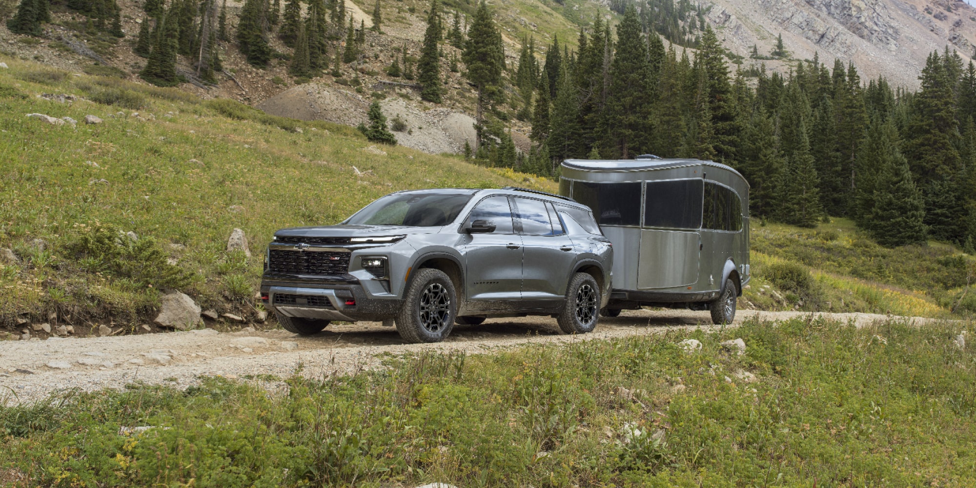 A 2027 Chevy Traverse Parked With a Trailer Attached in an Outdoor Setting.