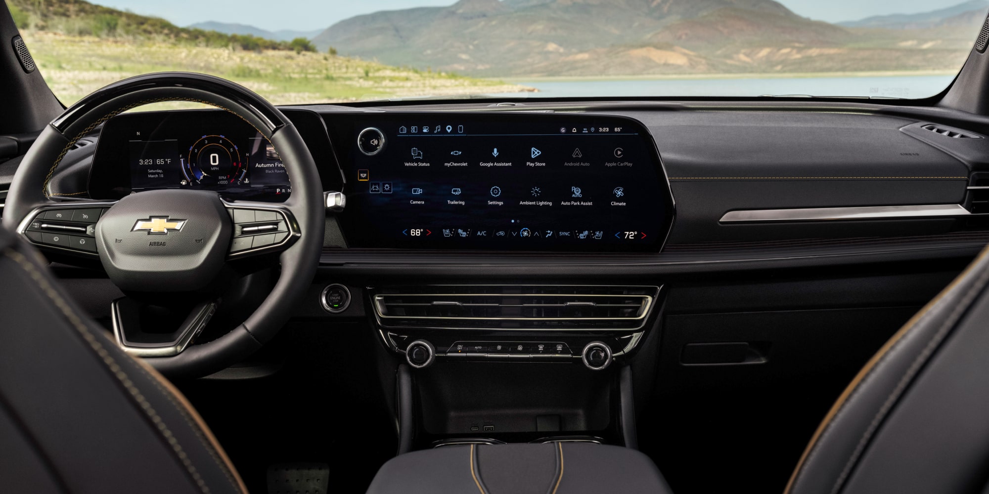 Back Seat View of the 2027 Chevy Traverse Front Row Interior and Dashboard While Outlooking the Mountains