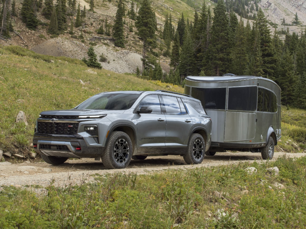 A 2027 Chevy Traverse Parked With a Trailer Attached in an Outdoor Setting.