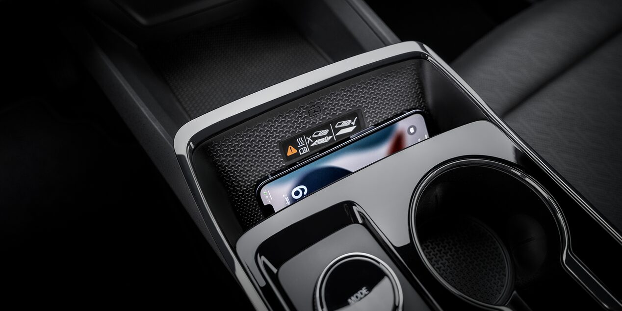 A Center Console Storage Area Inside a Chevrolet Equinox Holding Small Personal Items Next to Dual Cupholders.