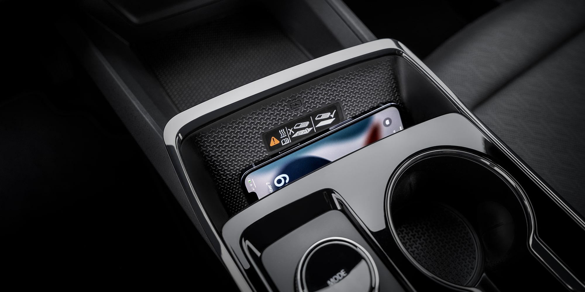 A Center Console Storage Area Inside a Chevrolet Equinox Holding Small Personal Items Next to Dual Cupholders.