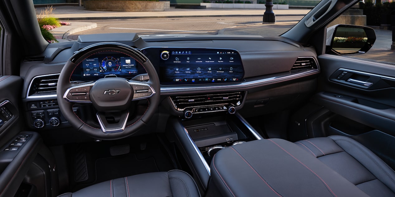 The Interior of a Chevrolet Tahoe Showcasing a Leather-Wrapped Steering Wheel, a Large Digital Infotainment Screen, and Premium Cabin Materials.