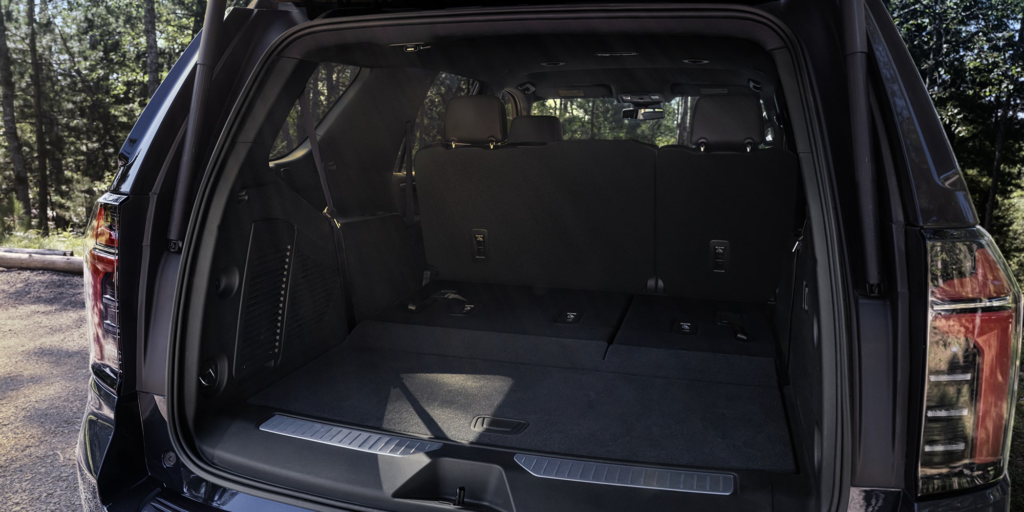 The Rear Cargo Area of a Chevrolet Tahoe With the Liftgate Open Showing a Spacious Interior Ready for Loading.