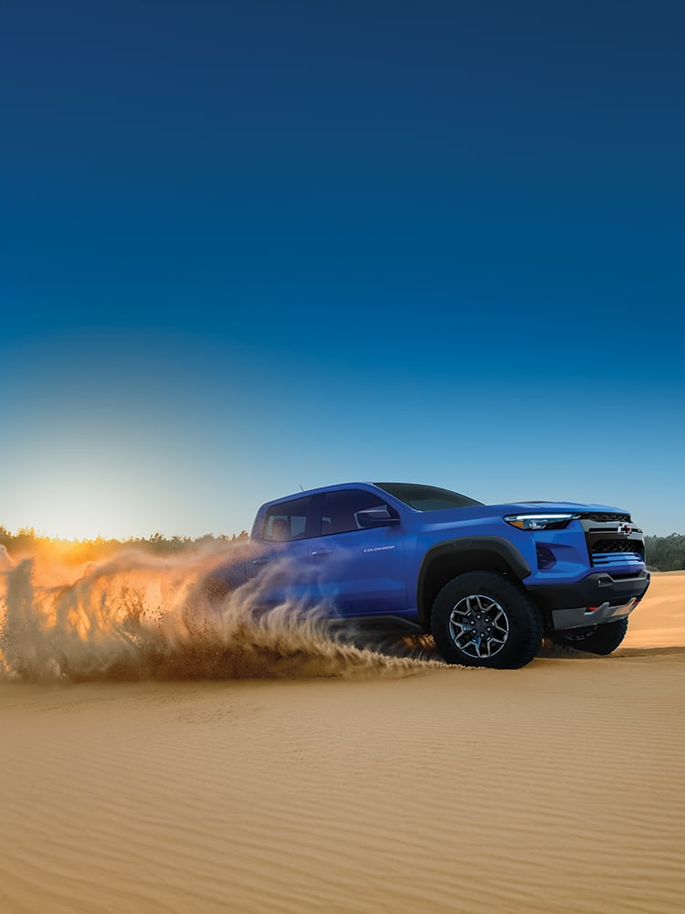 Side view of a 2026 Blue Chevy Colorado in a desert