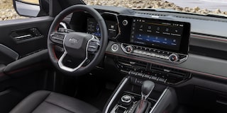 2026 Chevy Silverado Truck Driving Through Muddy Terrain with Splashes of Water