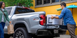 2026 Chevy Silverado Truck Driving Through Muddy Terrain with Splashes of Water