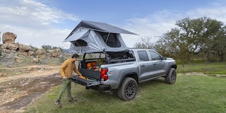 2026 Chevy Silverado Truck Driving Through Muddy Terrain with Splashes of Water