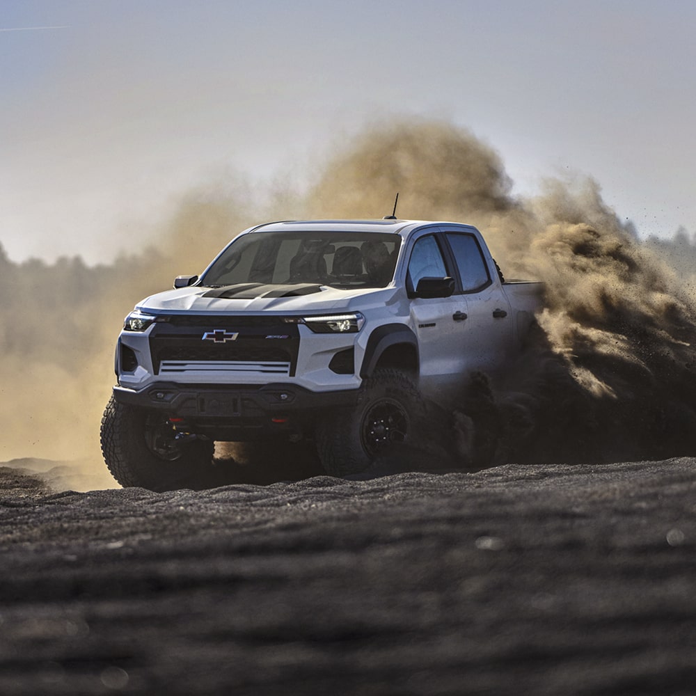 A 2026 Chevrolet Colorado Sliding Through Deep Dirt and Throwing Up a Large Cloud of Dust.