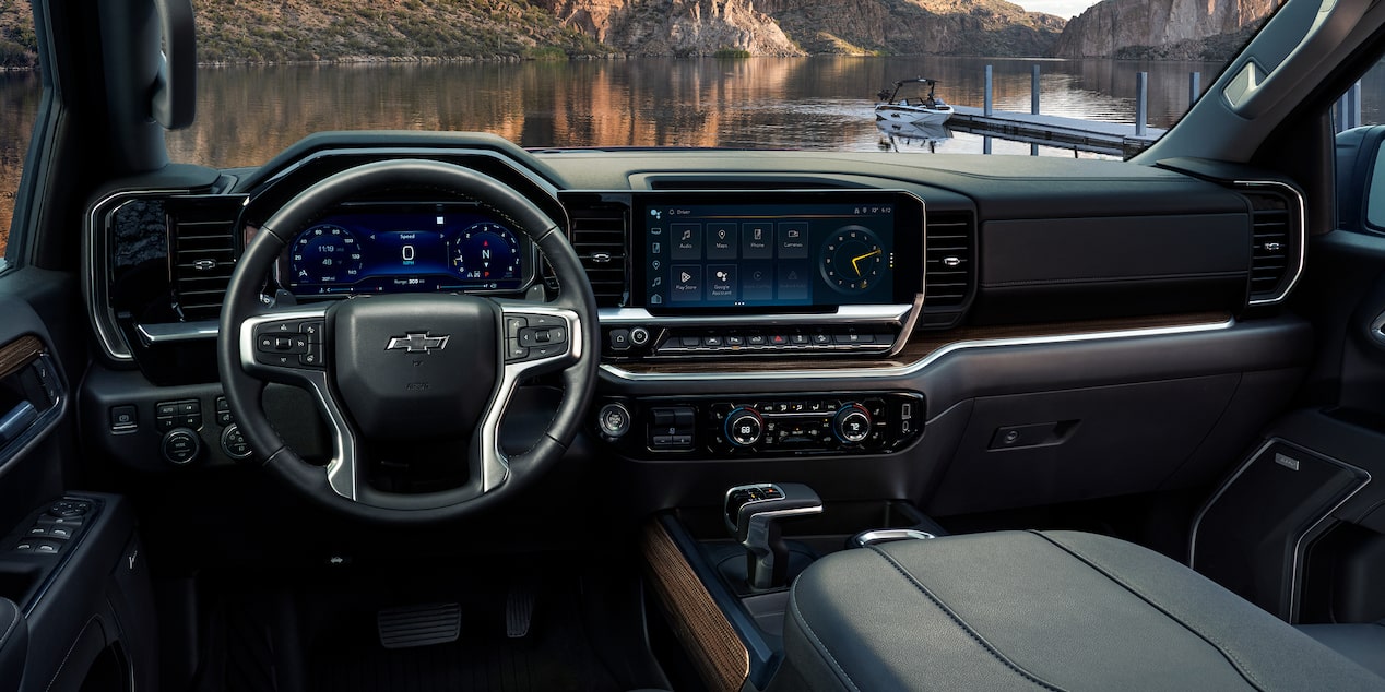 Interior View of 2026 Chevy Silverado Featuring Modern Dashboard and Touchscreen Display with Scenic Lake Background