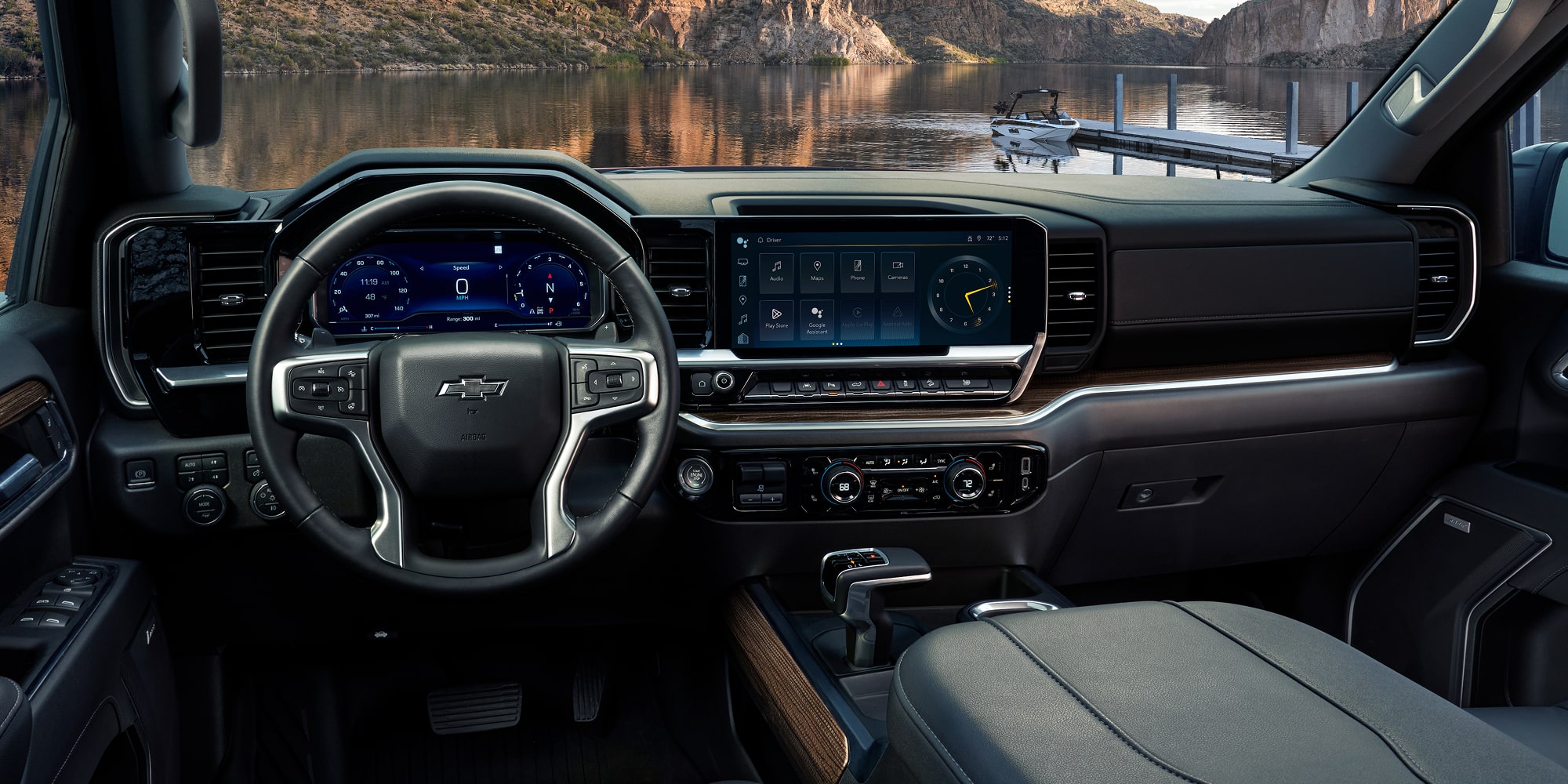 Interior View of 2026 Chevy Silverado Featuring Modern Dashboard and Touchscreen Display with Scenic Lake Background