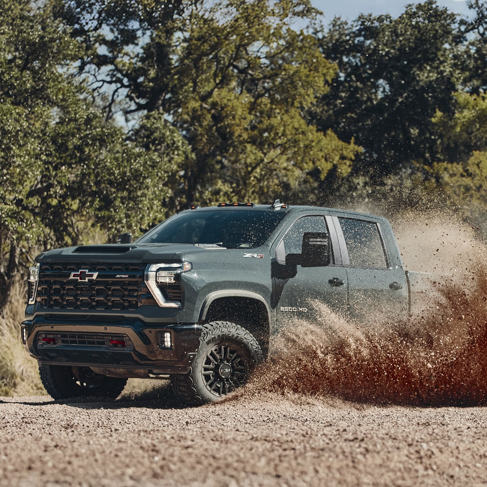 Side View of a 2026 Chevy Silverado HD Driving Off-Road Through a Desert