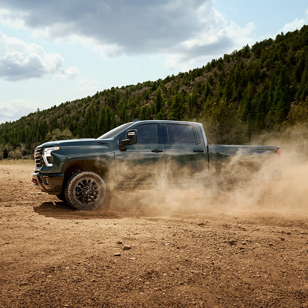 Side View of a 2026 Chevy Silverado HD Driving Off-Road Through a Desert