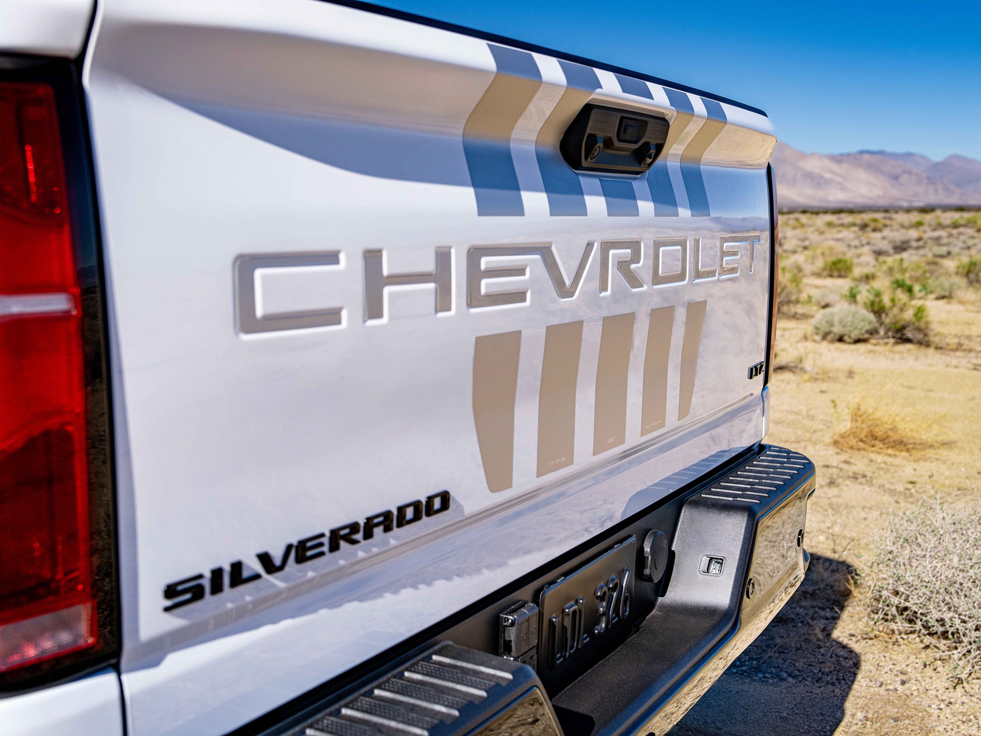 The Rear View of a White Chevrolet Silverado HD Stars and Steel Truck, Featuring Stripes and Silverado Text.